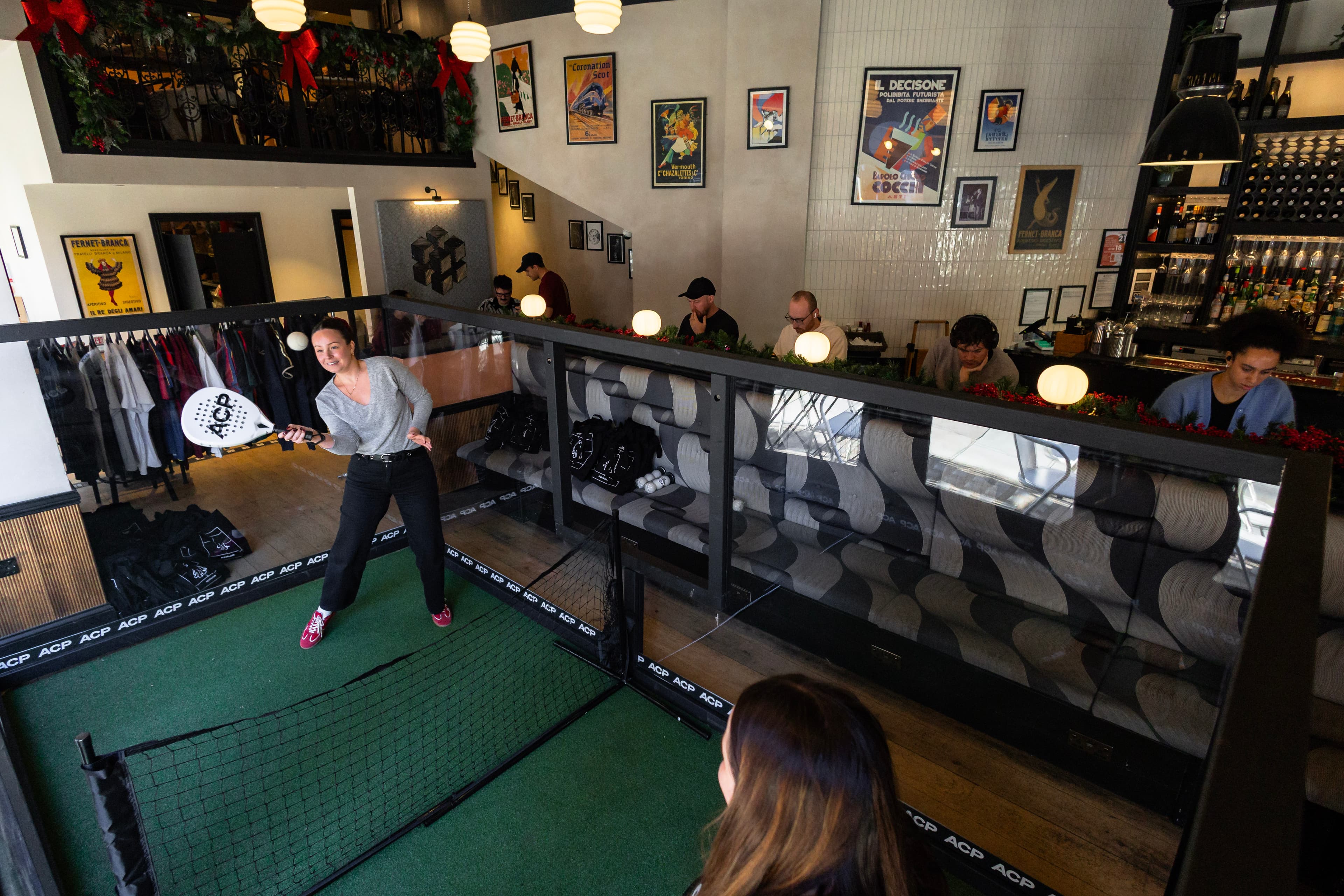 Player mid-shot on the micro court inside Haunt bar